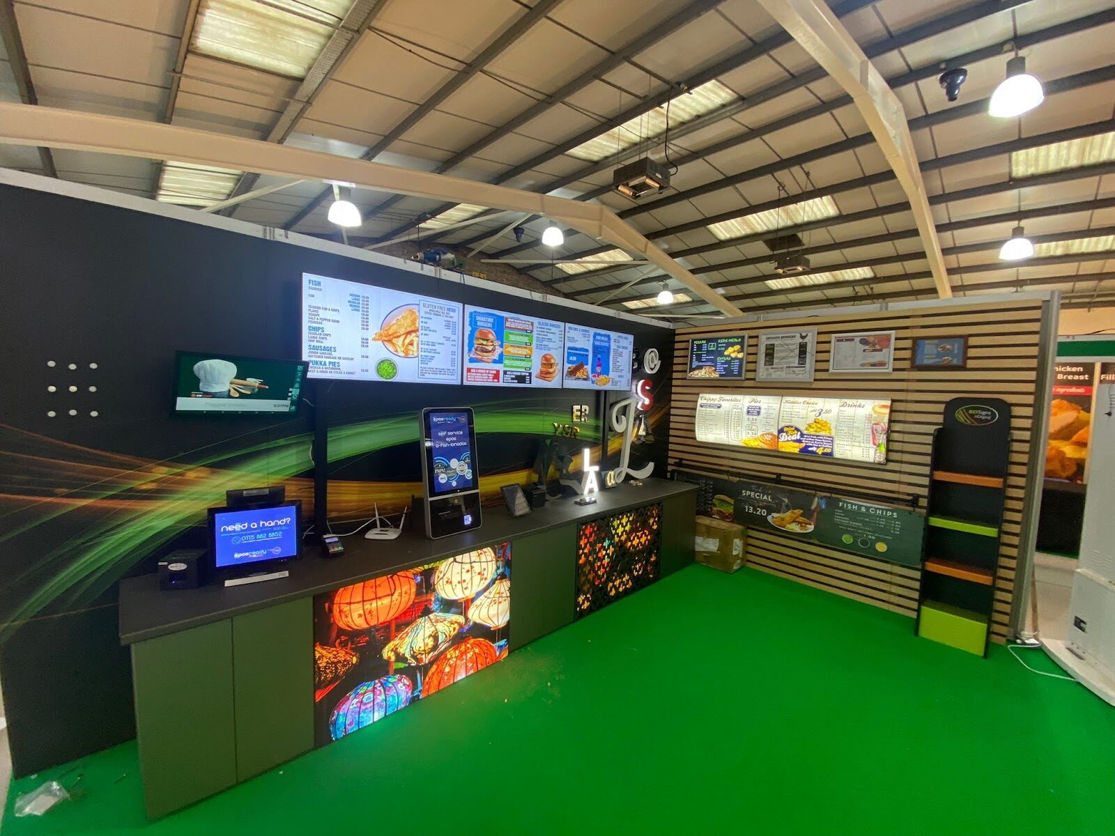The BD Signs showroom in Nottingham — digital menu boards, an illuminated counter and printed menus on display